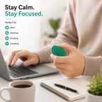 Office worker holding a Kalmzo sensory fidget stone while working to improve focus and reduce stress.
